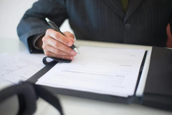 Swiss Salary Payroll Services professional finalizing employee payroll paperwork