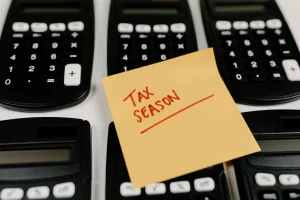 Swiss Payrolling Software compliance concept with calculators and handwritten tax season note