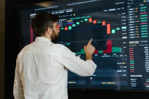 A man checking a dashboard on timekeeping software that displays tracked hours, productivity metrics, and work activity
