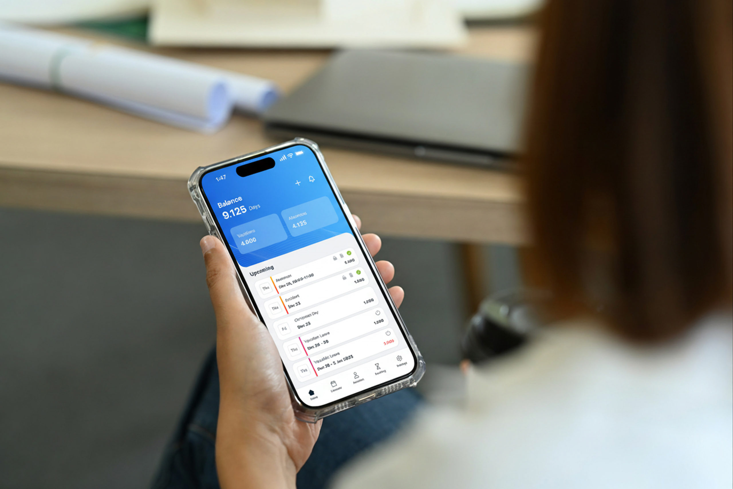 Woman using the Applic8 time and absence tracking software on a smartphone to check work hours, submit leave requests, and manage attendance.
