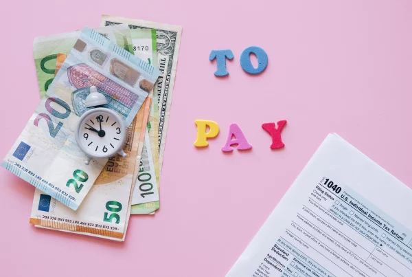 Illustration of money, tax documents, and financial paperwork representing international employee payroll, overseas salary payments, tax compliance, and cross-border workforce management.
