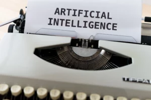 Une machine à écrire affichant les mots « Intelligence artificielle », illustrant l'impact de l'IA sur les emplois dans le secteur de la paie et l'automatisation.